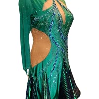 Emerald Majesty Signature Latin dress showing dynamic skirt movement with emerald shimmer inserts designed for rhythm and hip action