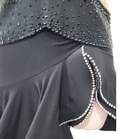 Back view of Emmy convertible ballroom gown with nude illusion open-back design, black crystal bodice, and long flowing Smooth skirt.