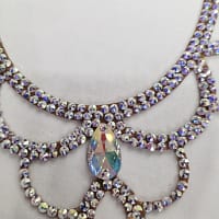 Close-up of center teardrop crystal detail on a ballroom dance necklace