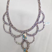 Full flat lay view of crystal ballroom necklace on white background