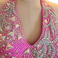 Neckline detail of halter Latin dress with crystal trim and geometric stones
