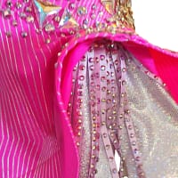 Skirt detail showing flared pink panels and rhinestone fringe accents
