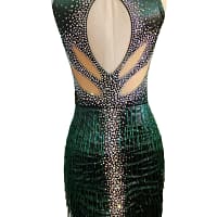 Back view of emerald green Latin dress with oval open back and crystal details
