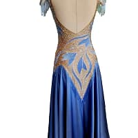 Back view of the Yvette ballroom gown featuring an open scoop back, crystal-trimmed neckline, and elegant sky blue ballroom skirt.