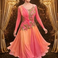 Professional dancer in the Silken Radiance gown, showing movement in the coral ombre sunburst pleated skirt.