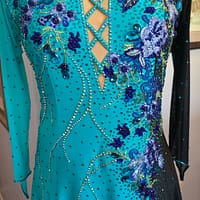 Electric Bloom ballroom dress bodice detail with blue floral appliqué and rhinestone crystals