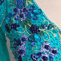 Electric Bloom ballroom dress shoulder detail with intricate blue floral crystals and beadwork