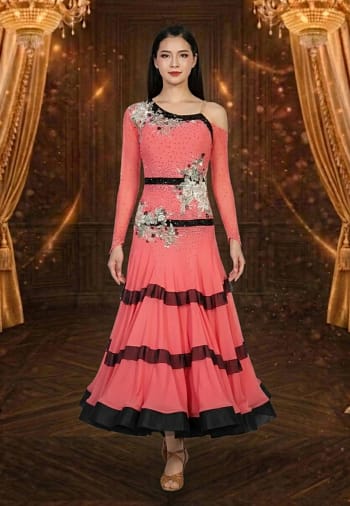 Coral Rhythm ballroom dance dress with black trim, floral embellishments, long sleeves, and layered flowing skirt