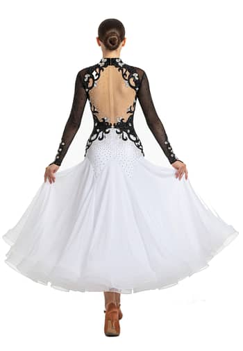 Lauren ballroom gown — back view — Long-sleeved black and white dress with a deep open-back design edged with black scrolling appliqué and clear crystals, over a nude mesh panel, leading to a white stoned skirt.