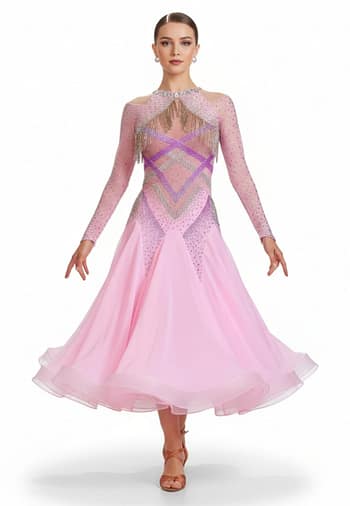 Labana ballroom gown — front view — Long-sleeved, pale pink Standard gown with a sheer mesh yoke, detailed geometric stoning in purple and AB crystals, and silver beaded fringe across the chest and shoulders.