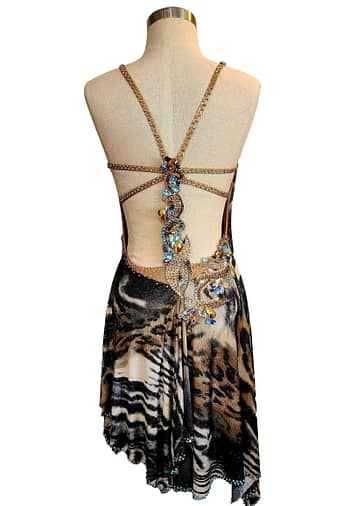 Kaya Latin dress — back view — backless Latin gown with a multi-strap design and a central cluster of large blue and gold stones over animal print fabric.