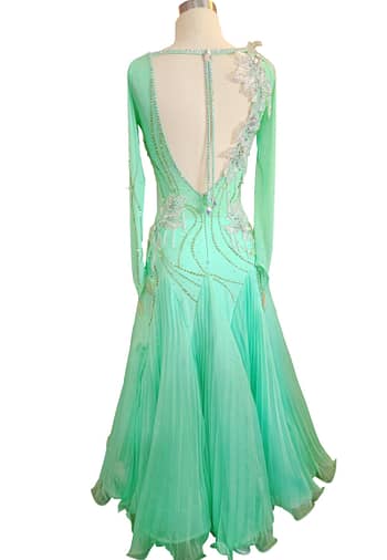 Calla ballroom dress — back view — low V-back with pleated georgette skirt and asymmetrical flower shoulder detail.