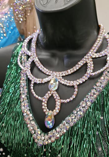 Crystal ballroom necklace styled on mannequin with green competition dance dress