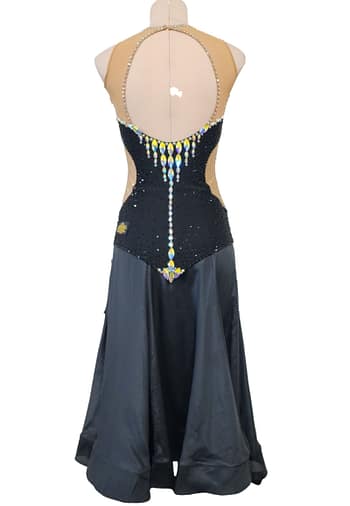 Back view of Midnight Rhythm convertible ballroom gown with nude illusion open-back design, black crystal bodice, and long flowing Smooth skirt.