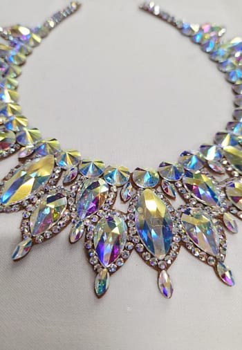 Close-up of oversized Crystal AB stones on a large ballroom necklace with high-reflection sparkle.