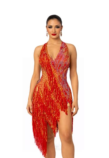 A woman wearing the Inferno Cascade Latin dance dress featuring red fringe, gold sequins, and intricate crystal embellishments.