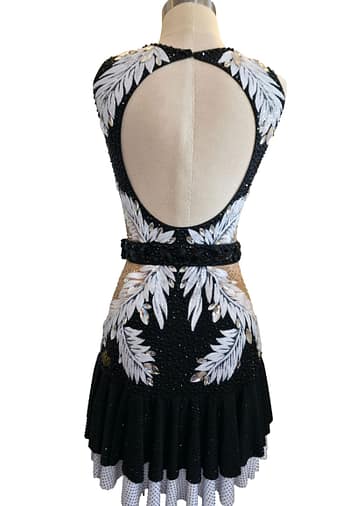 Onyx Whisper Performance Series Latin dress with black rhinestone bodice and white feather-inspired embellishments worn by model