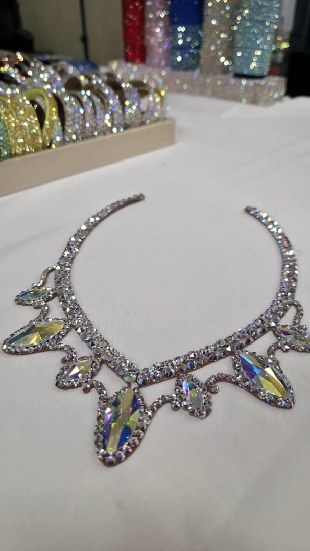 Detailed view of the center crystal arrangement on Luminous ballroom necklace featuring elegant layered stones.