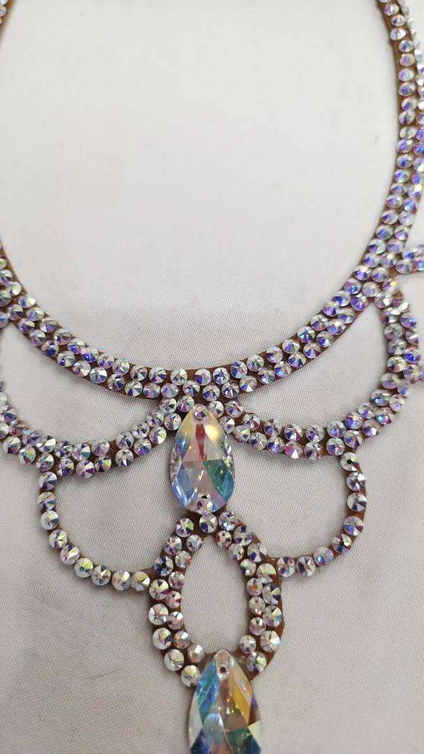 Close-up of center teardrop crystal detail on a ballroom dance necklace