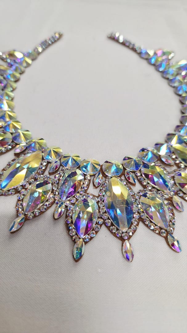 Close-up of oversized Crystal AB stones on a large ballroom necklace with high-reflection sparkle.
