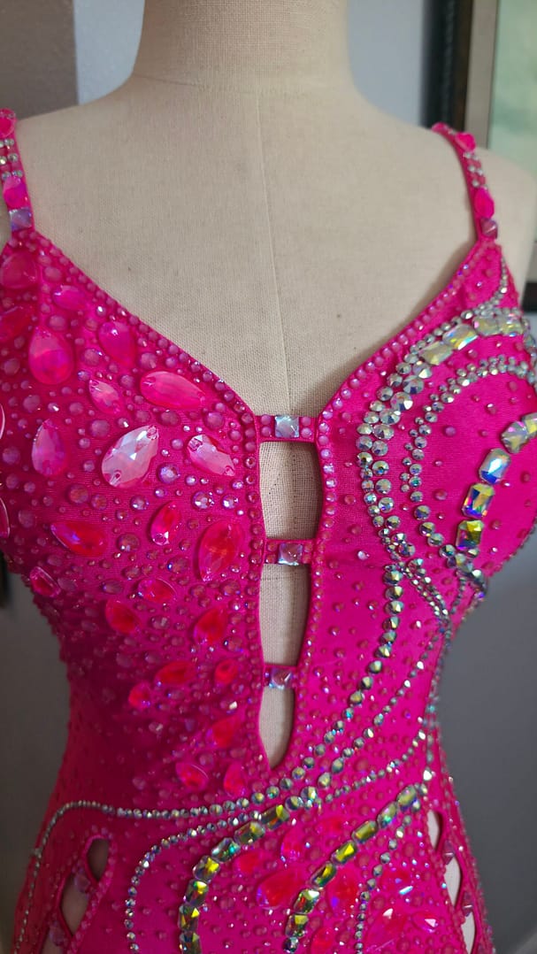 Close-up of Malibu Dream ballroom gown bodice with pink stones and shimmering rhinestones