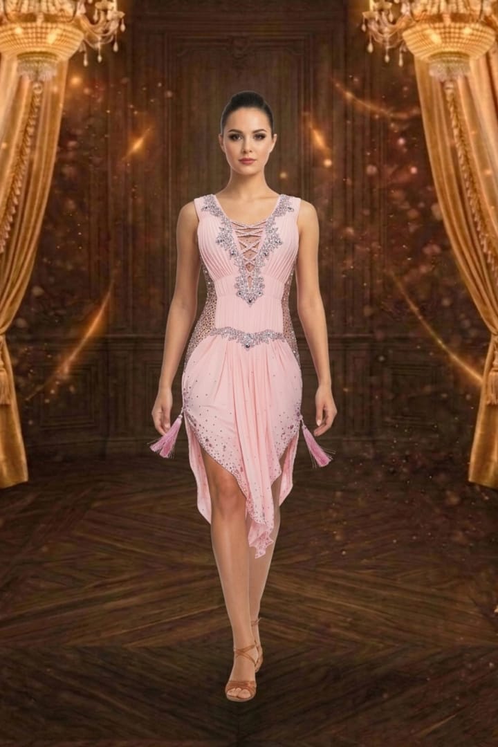 Blush Radiance Latin dress — front view — pleated peach fabric with lace-up plunge, crystal accents, and tassels