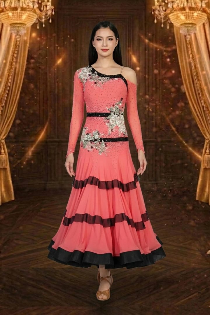 Coral Rhythm ballroom dance dress with black trim, floral embellishments, long sleeves, and layered flowing skirt