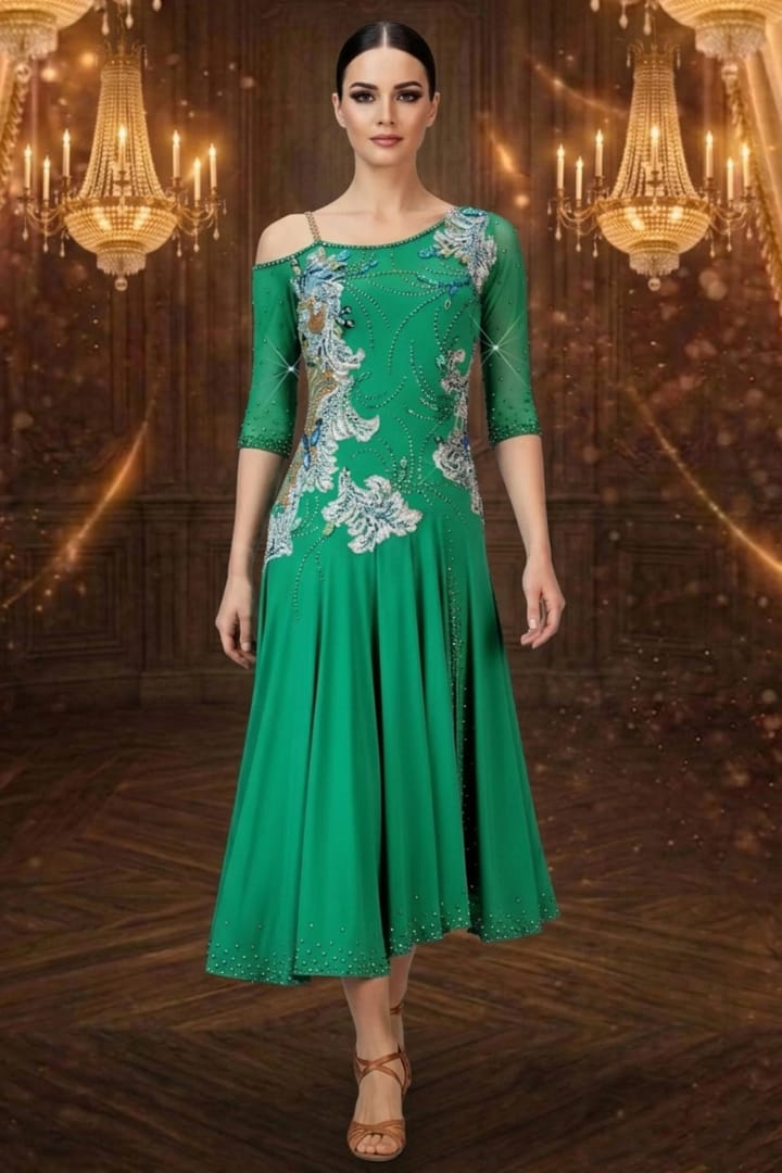 Emerald Motion Latin dress — front view — Bright emerald green Latin dress with three-quarter length sheer sleeves, an off-the-shoulder strap detail, and a heavily stoned bodice with flowing white and blue floral appliqués.