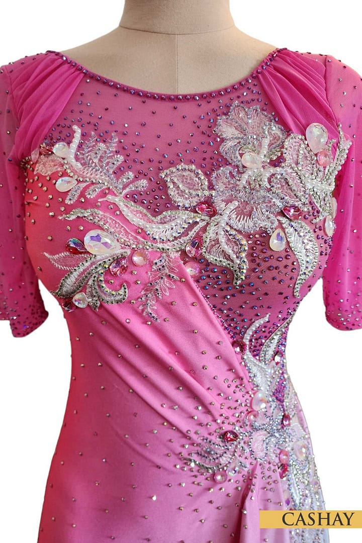 Gia Latin dress — bodice detail — ruched front bodice featuring intricate silver floral appliqué, crystal beadwork, and sheer pink mesh sleeves.