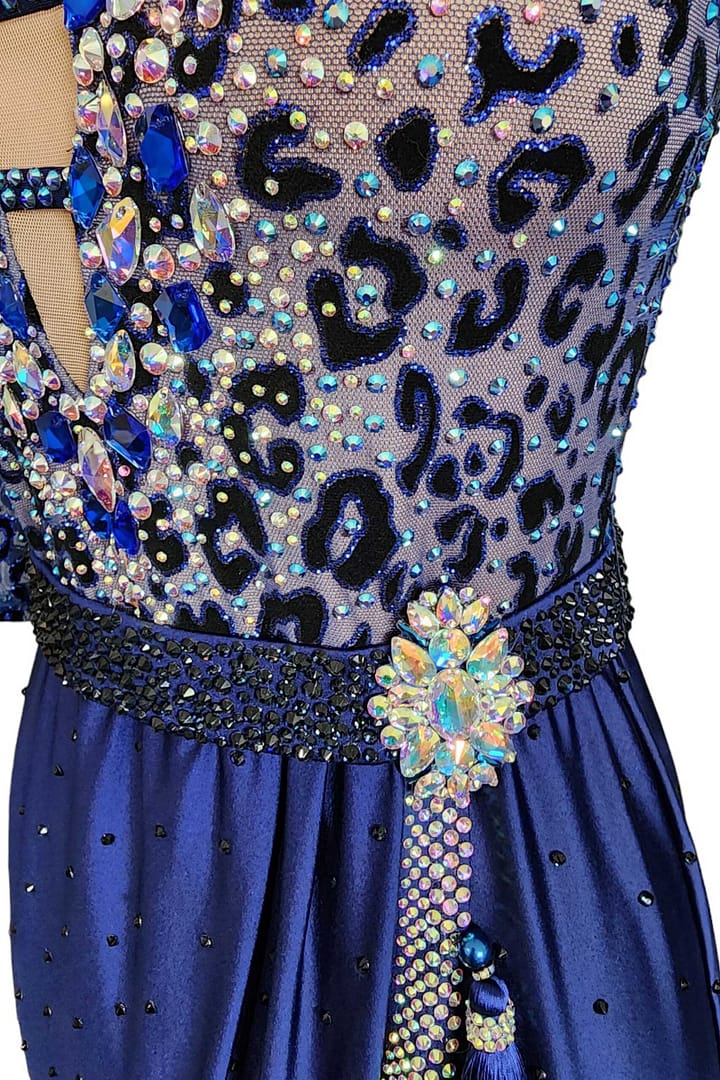 Pala Latin Dress — stonework close-up — Macro detail of the waist showing the black beaded belt, the large crystal brooch accent, and the sparkling blue-on-black leopard print stoning.