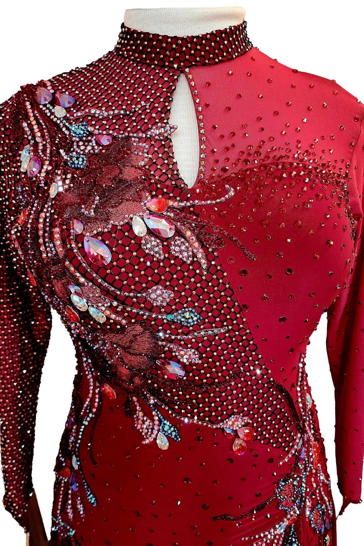Talia Latin dress — bodice detail — close-up of fishnet mesh, red 3D floral appliqué, and iridescent teardrop crystals.