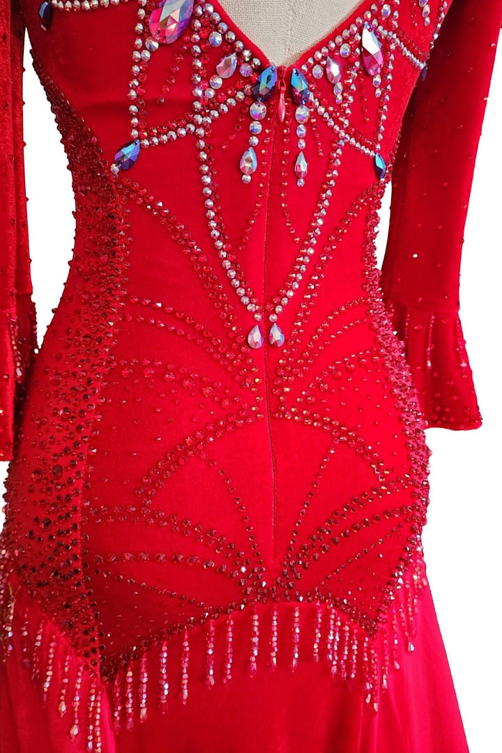 Amira Ballroom dress — back detail — close-up of the crystal chain accents hanging from the back straps onto the nude mesh panel.