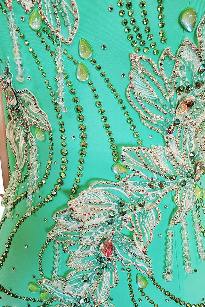 Calla ballroom dress — stonework close-up — lime green rhinestones and pear-shaped AB crystals on the bodice.