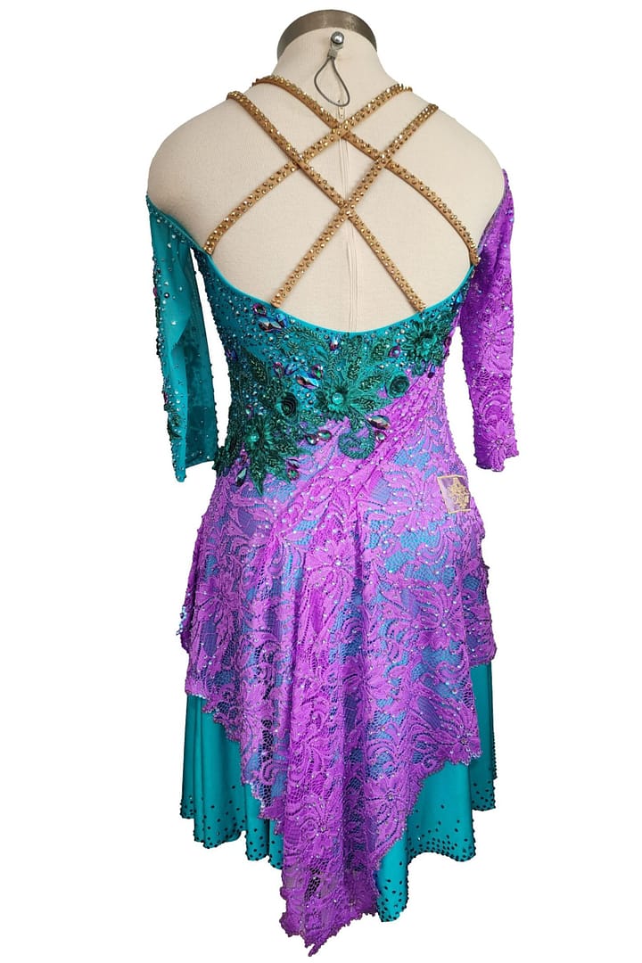 Lera Latin dress — back view — turquoise and purple lace, open back, and gold beaded criss-cross straps.