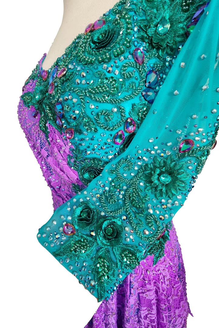 Lera Latin dress — sleeve detail — long turquoise mesh sleeve with green embroidery, small rhinestone clusters, and purple lace.