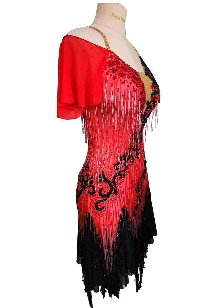 Nyla Latin dress — side view — red off-shoulder sleeve, black fringe, and rhinestone bodice.