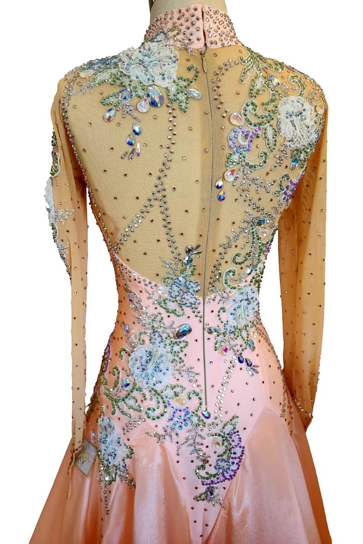 Peach ballroom gown — back view — elegant ballroom dress featuring a full back sheer panel adorned with scattered crystals and a zipper closure.