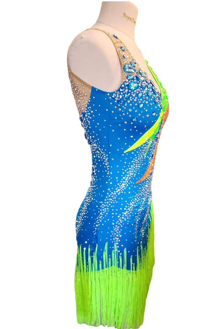 Rio Swirl Latin dress — side view — showcasing the bold striped pattern on the side and the layered fringe movement.