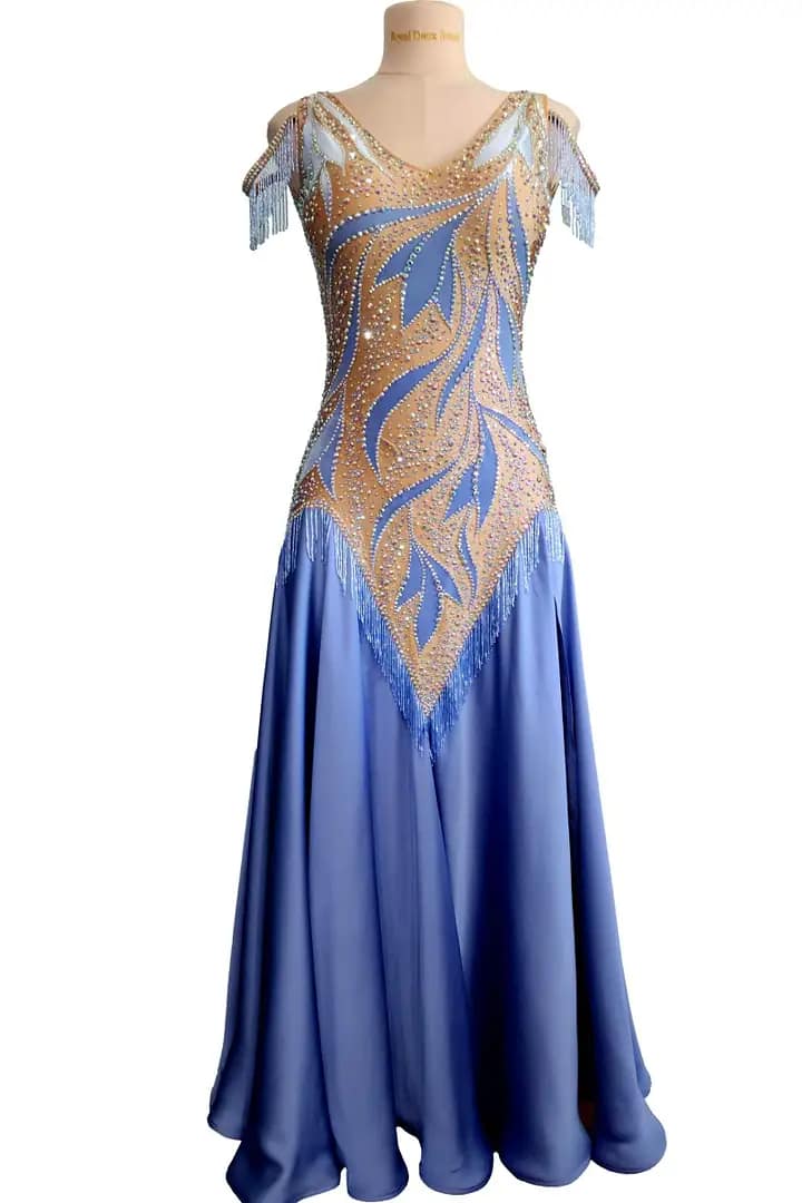 Blue Silhouette Atelier ballroom dress displayed on a mannequin with crystal-framed neckline, shoulder fringe accents, and soft full-length blue skirt.