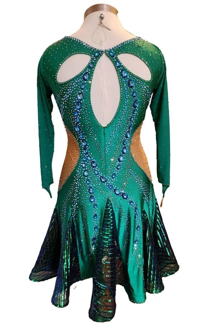 Back view of Emerald Majesty Signature Latin dress with oval open-back cutout, crystal trim, and short skirt with shimmering movement panels