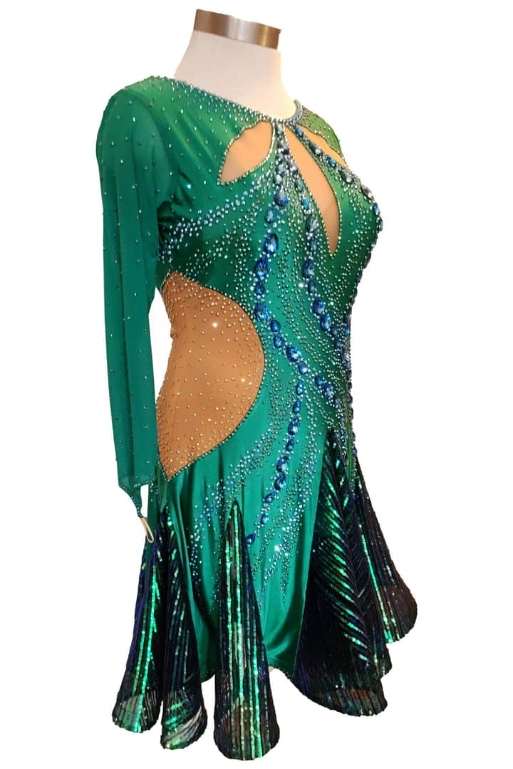 Emerald Majesty Signature Latin dress showing dynamic skirt movement with emerald shimmer inserts designed for rhythm and hip action