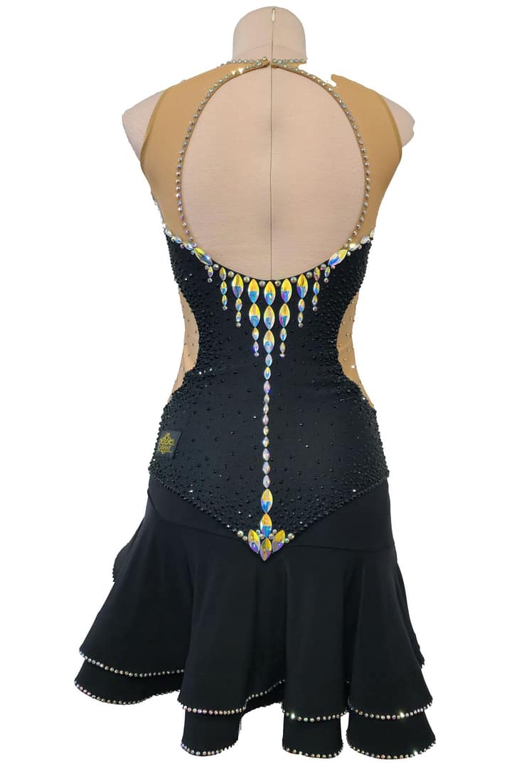 Back view of Midnight Rhythm Latin mode dress featuring open illusion back, cascading crystal drop design, and layered black ruffle skirt.