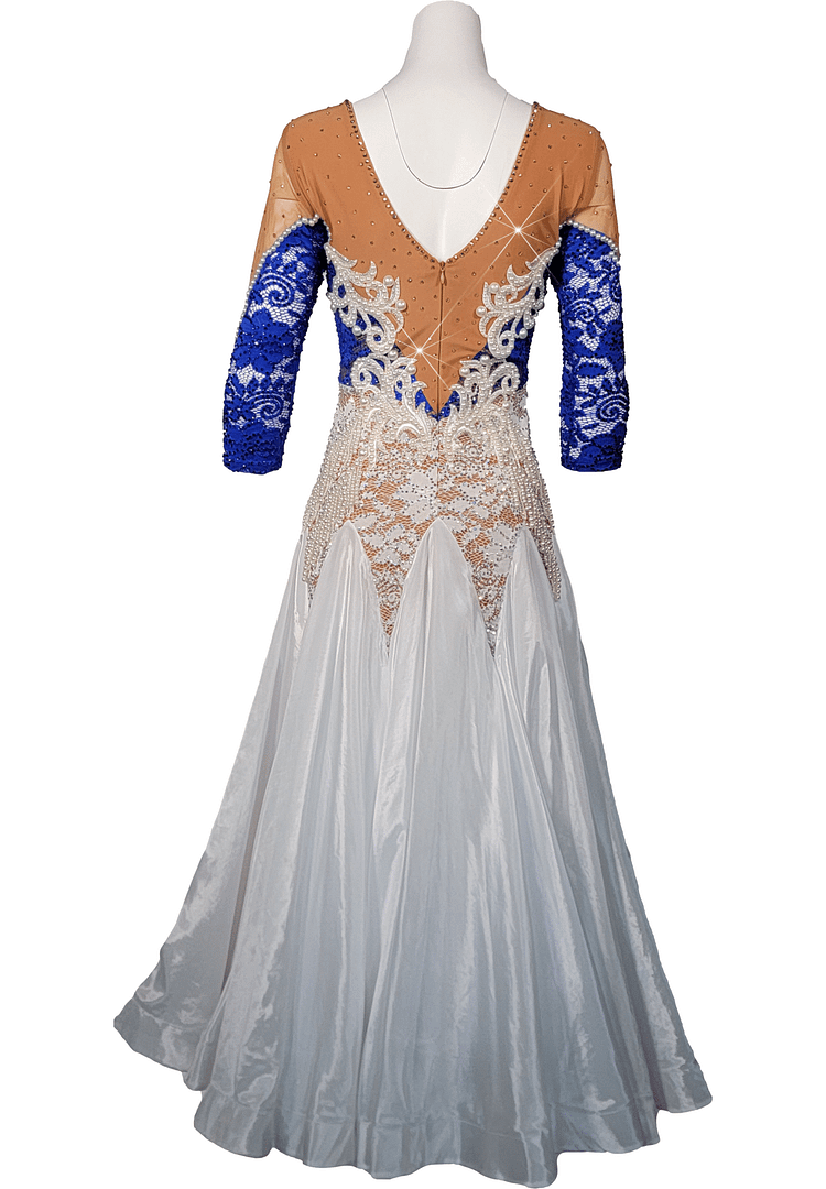 Galene ballroom gown — back view — Deep V-back bodice with blue crystal-encrusted lace and white lace appliqués over nude mesh, and a vertical zipper closure.