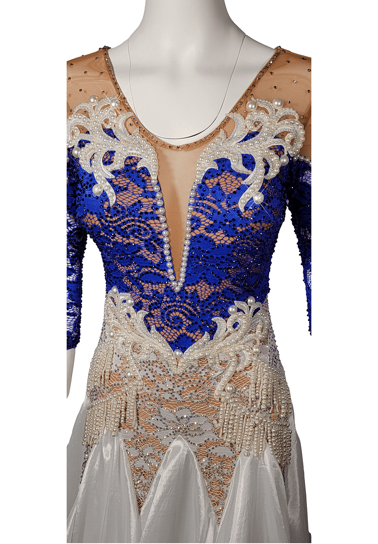 Galene ballroom gown — bodice detail — Close-up of the neckline showing a nude mesh yoke and deep V-plunge, decorated with white lace appliqué, strands of pearls, and a border of small rhinestones.