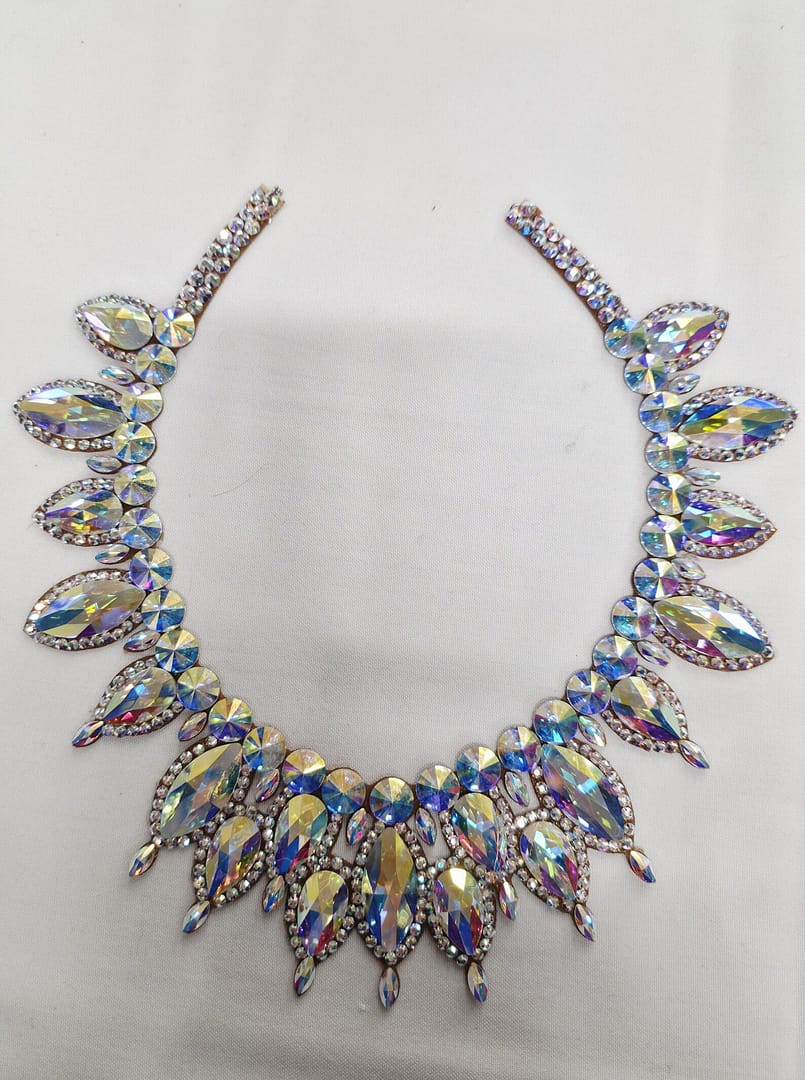 Detailed view of the center section of a large crystal ballroom necklace featuring layered statement stones.