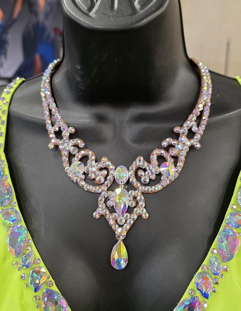 Crystal ballroom necklace displayed at a ballroom dance event, showcasing professional competition jewelry craftsmanship.