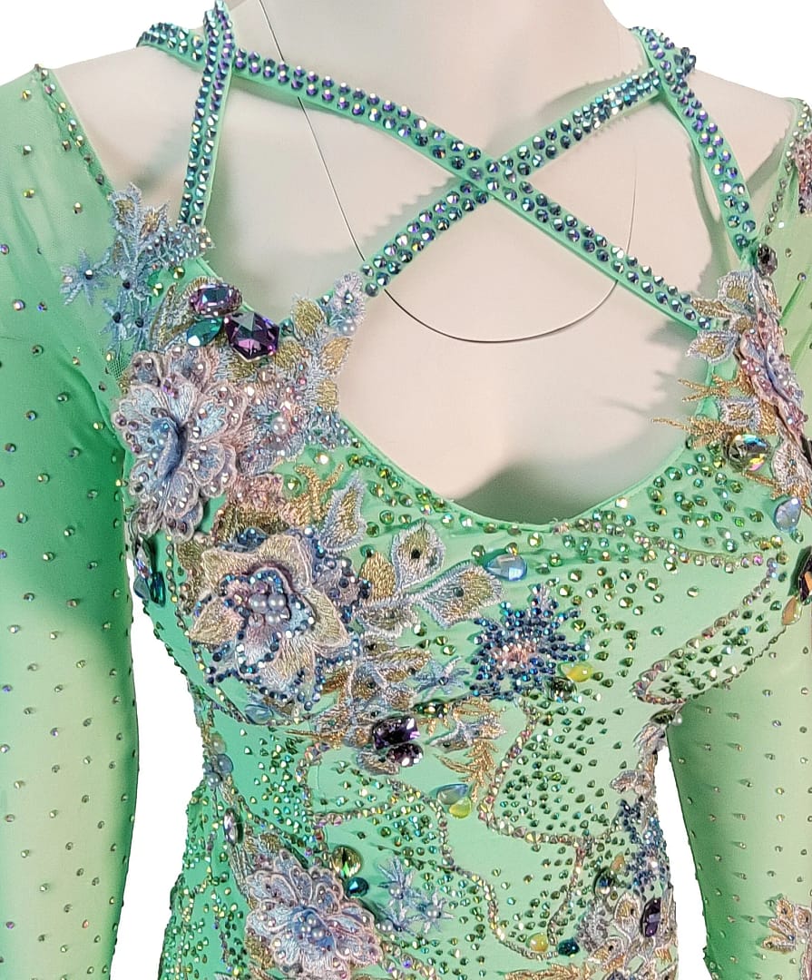 Rain ballroom dress — bodice detail — close-up of the pastel green bodice, showing delicate embroidered flowers in lavender and blue, surrounded by abundant stoning and gold thread.