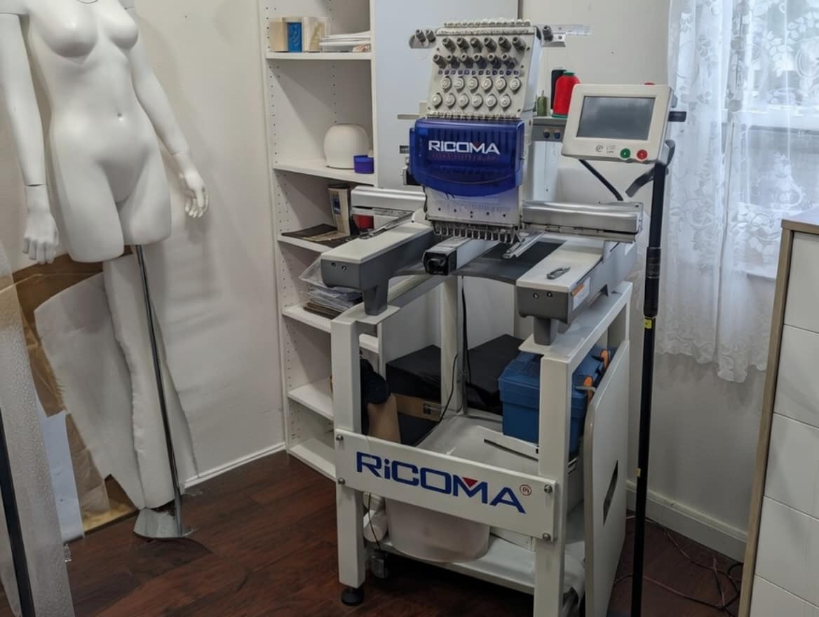 Industrial Ricoma embroidery machine for detailing custom ballroom gowns.