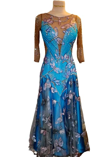 Dragonfly ballroom dress — in mannequin — Standard gown with nude mesh three-quarter sleeves and a bodice covered in large, iridescent dragonfly appliqués and scattered crystals.
