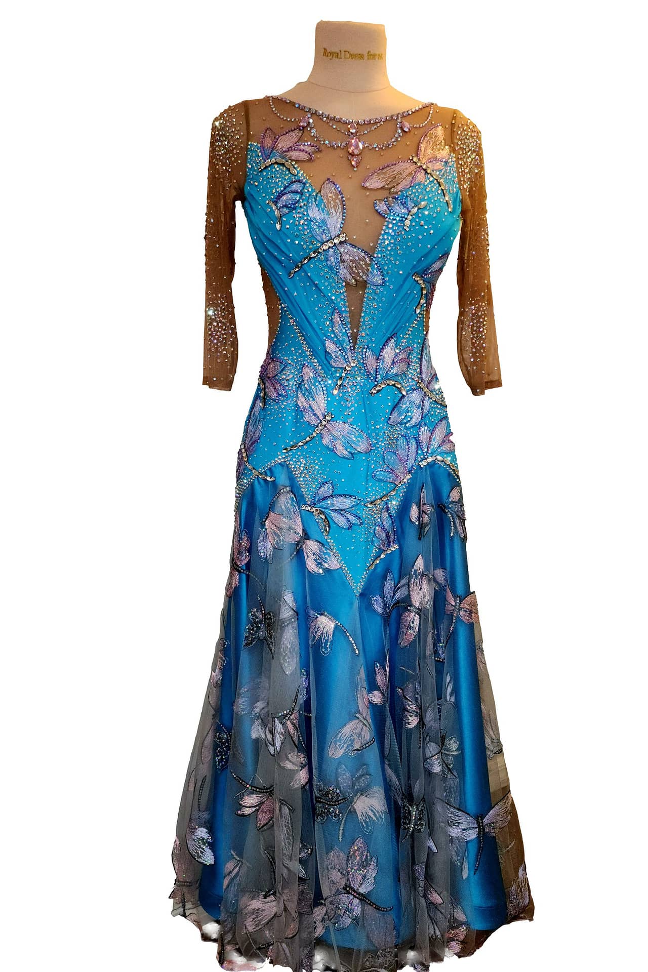 Dragonfly ballroom dress — in mannequin — Standard gown with nude mesh three-quarter sleeves and a bodice covered in large, iridescent dragonfly appliqués and scattered crystals.